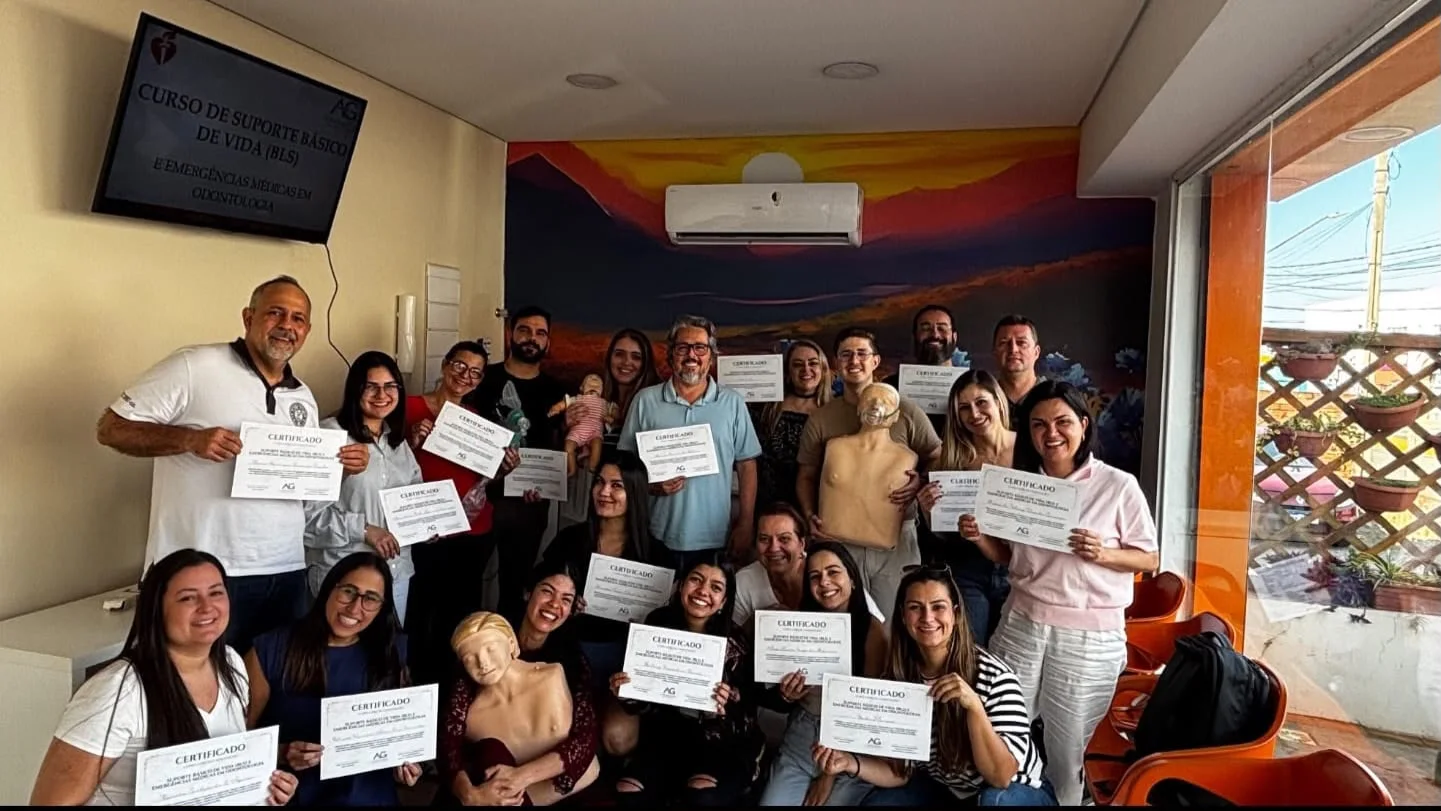 Participantes do curso de Suporte Básico de Vida com certificados e manequins de treinamento